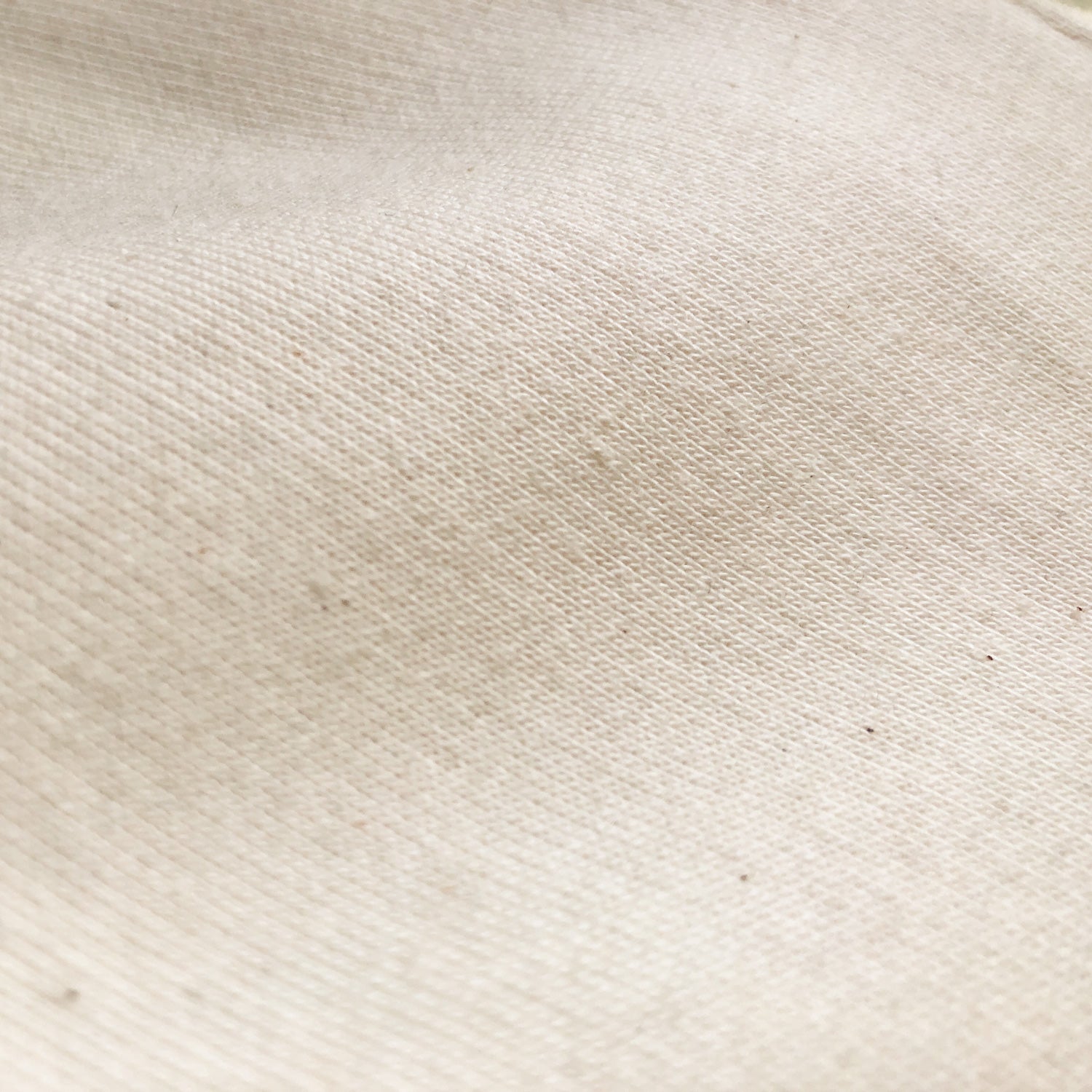 A close up of a natural colored fabric texture