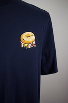 Close up of embroidered Bagel design on a navy T-Shirt by The Embroidery Crew
