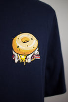 Close up of embroidered Bagel design on a navy T-Shirt by The Embroidery Crew
