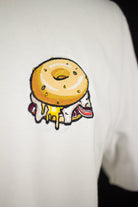 Close up of embroidered Bagel design on a white T-Shirt by The Embroidery Crew
