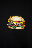 Close up of embroidered Burger design on a black T-Shirt by The Embroidery Crew
