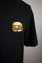 Close up of embroidered Burger design on a black T-Shirt by The Embroidery Crew