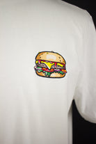 Close up of embroidered Burger design on a white T-Shirt by The Embroidery Crew