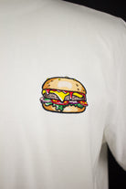Close up of embroidered Burger design on a white T-Shirt by The Embroidery Crew