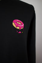 Close up of embroidered Donut design on a black Sweatshirt by The Embroidery Crew