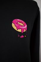 Close up of embroidered Donut design on a black Sweatshirt by The Embroidery Crew