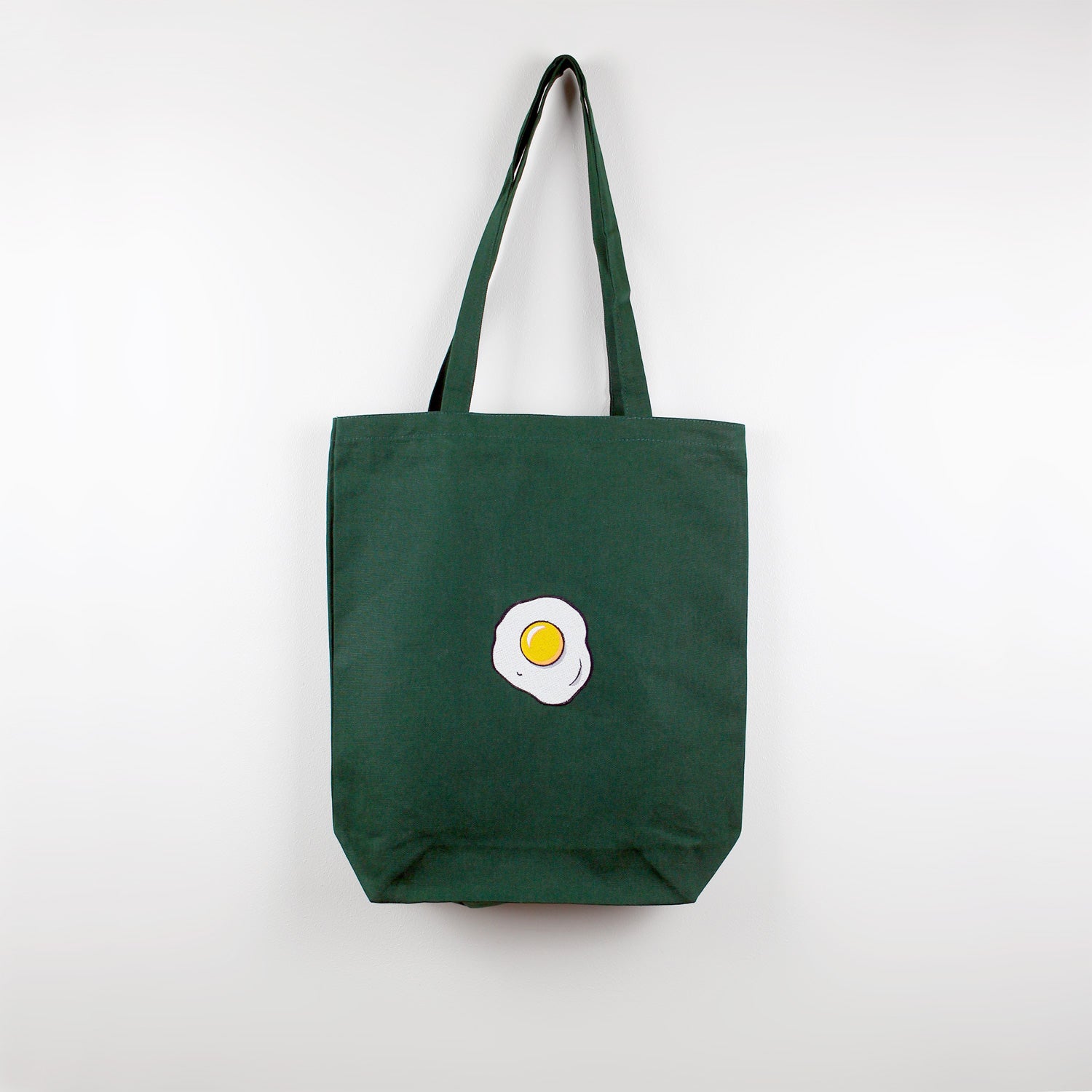 A green tote bag with Egg embroidery by The Embroidery Crew