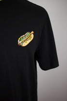 Close up of embroidered Hotdog design on a black T-Shirt by The Embroidery Crew