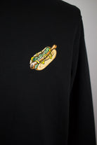 Close up of embroidered Hotdog design on a black Sweatshirt by The Embroidery Crew