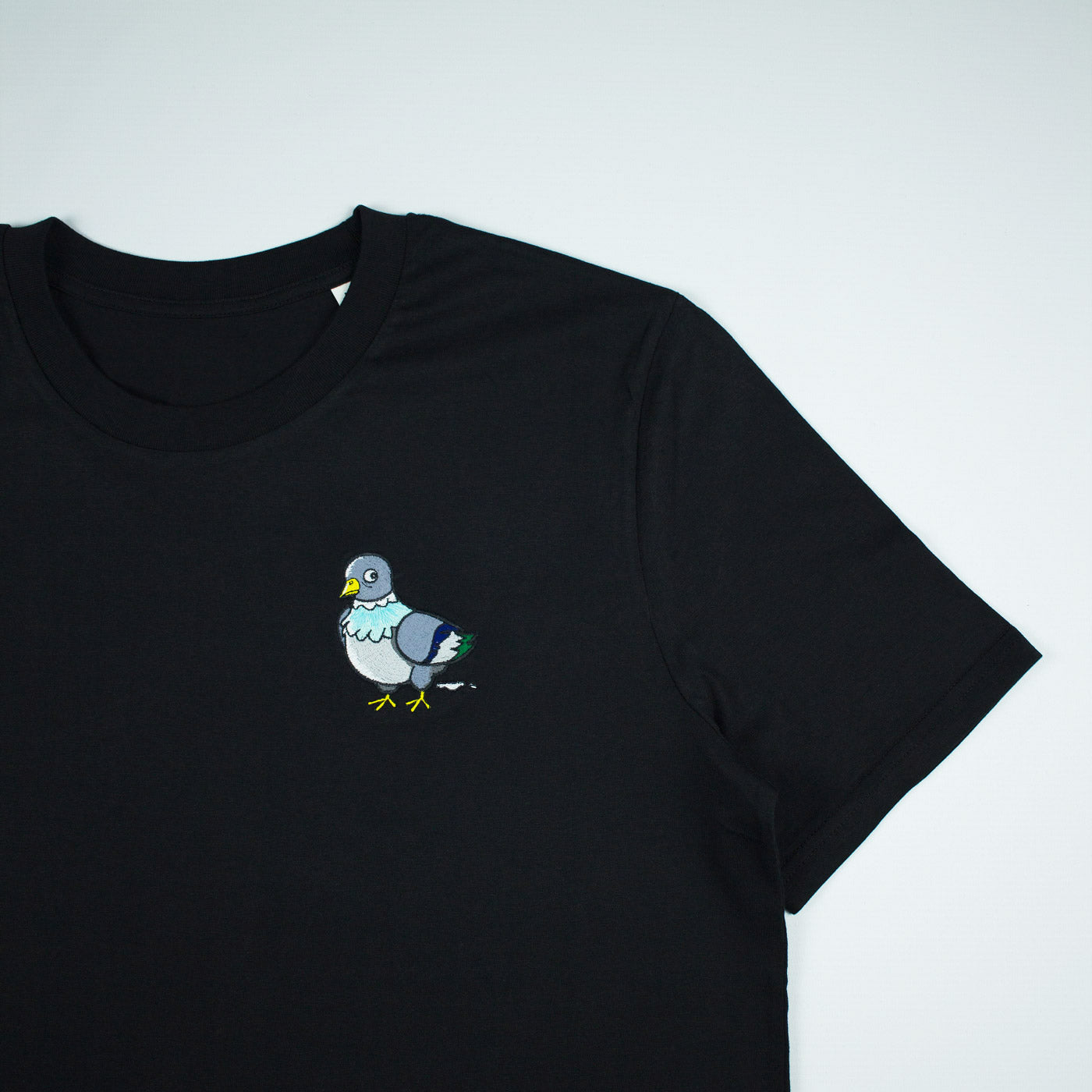 Black T-shirt with pigeon embroidery close up