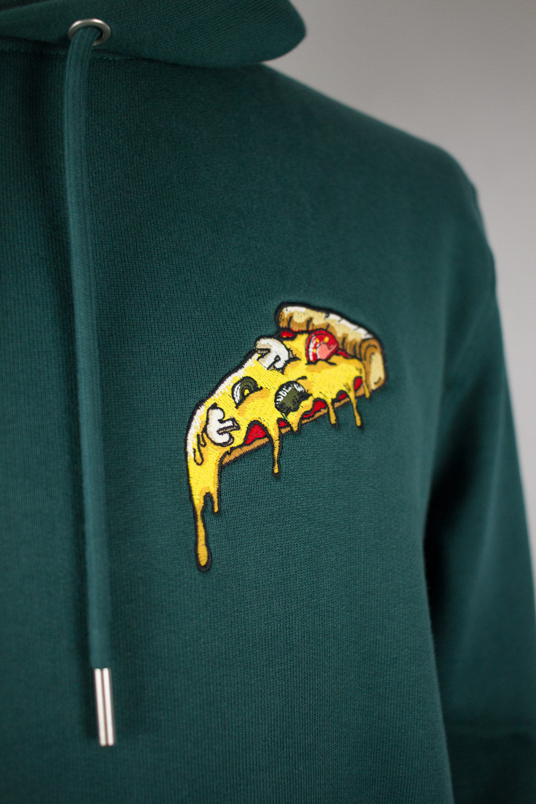 Close up of embroidered Pizza design on a green Hoodie by The Embroidery Crew