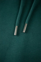Close up of drawstrings from a green Hoodie by The Embroidery Crew