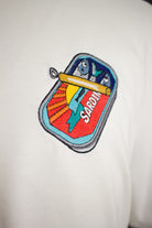 Close up of embroidered Sardines design on a white T-Shirt by The Embroidery Crew